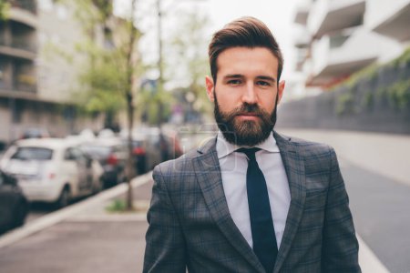 Photo for Young elegant professional executive bearded businessman posing outdoors confident and reassuring - Royalty Free Image
