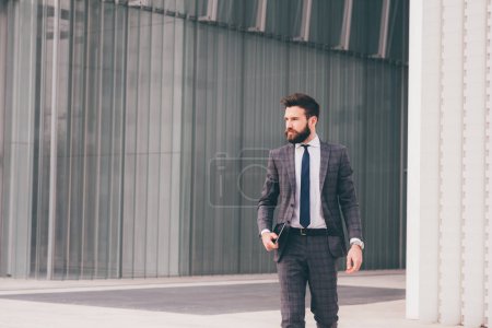 Photo for Confident and professional elegant bearded businessman walking outdoor strong and trusty - Royalty Free Image
