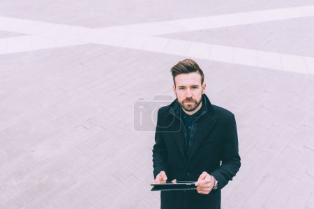 Photo for Young bearded man outdoor business using tablet - Royalty Free Image
