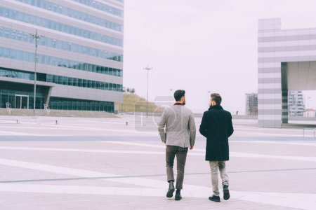 Photo for Back view two young business men outdoor walking - Royalty Free Image