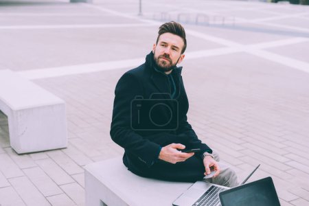 young bearded business man using smart phone