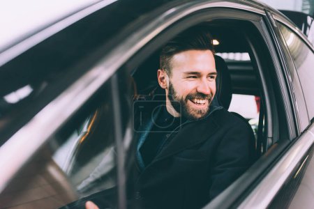 Photo for Young bearded businessman sitting car - Royalty Free Image