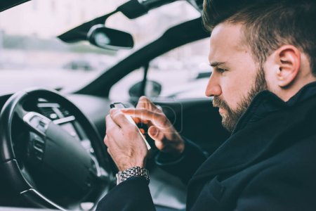 Photo for Young bearded business man sitting car smart phone - Royalty Free Image