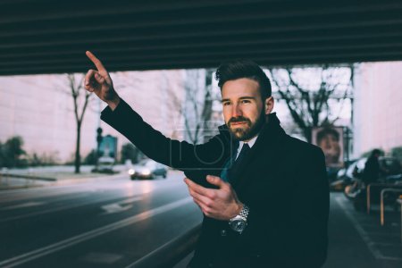 Photo for Young man business bearded asking taxi - Royalty Free Image