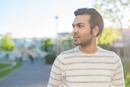 Photo for Portrait of young indian man serene and confident outdoors - Royalty Free Image