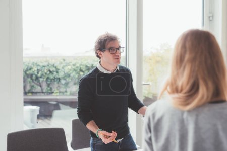 Photo for Portrait of young adult man moderating a workshop  - communication, creativity, education - Royalty Free Image