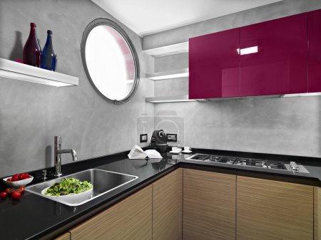 Téléchargez les photos : Intérieur de cuisine moderne au premier plan à gauche l'évier en arrière-plan sur le mur les unités murales rouges - en image libre de droit