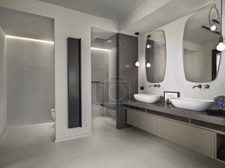 Photo for Corner view of the master bathroom with a countertop sink and a glimpse of the masonry shower. - Royalty Free Image