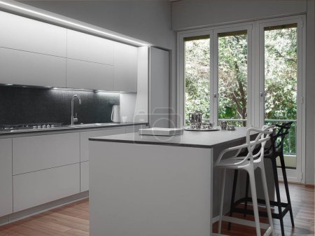 Foto de Interior de una cocina moderna en primer plano la cocina de la isla con taburetes el piso está hecho de madera - Imagen libre de derechos
