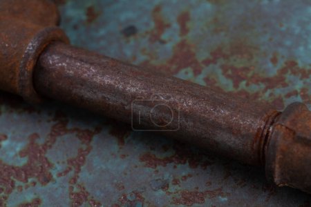 Rusty plumb tube on rusty metal wall background
