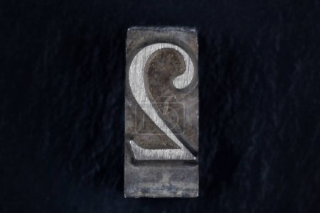 movable type alphabet number 2 on black background.