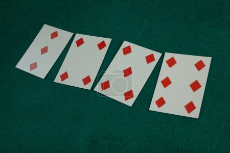 Old west era playing card on green gambling table. 3, 4, 5 , 6 of diamonds.