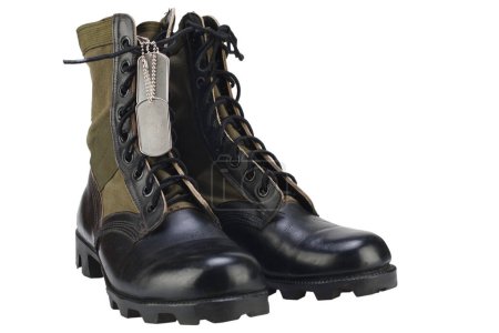 US army jungle pattern boots with dog tags isolated on white background