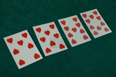 Old west era playing card on green gambling table. 7, 8, 9. 10 of hearts.