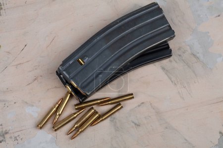 Ammunition with magazine on wooden background