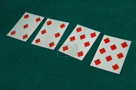 Old west era playing card on green gambling table. 5, 6, 7, 8 of diamonds.