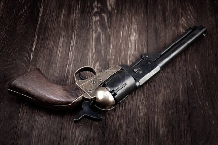 Old West gun. Percussion Army Revolver on wooden table
