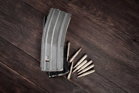 Ammunition with magazine on wooden background