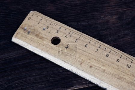Vintage old school ruler on wooden table