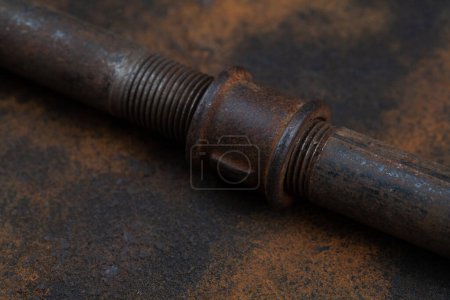 Rusty plumb tube on rusty metal wall background