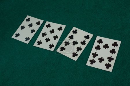 Old west era playing card on green gambling table. 7, 8, 9, 10 of spades.