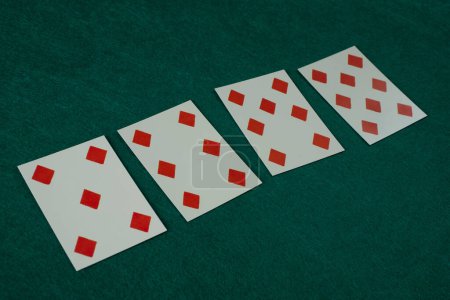 Old west era playing card on on green gambling table. 5,6,7,8 of diamonds.