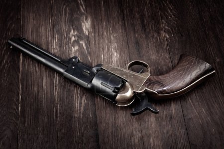 Old West gun. Percussion Army Revolver on wooden table