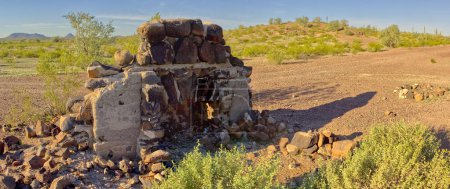 Photo for An old Fire Place Hearth sitting alone in the Arizona desert in the Gila Bend Mountains. It could be the remains of an old homestead that burned down. - Royalty Free Image
