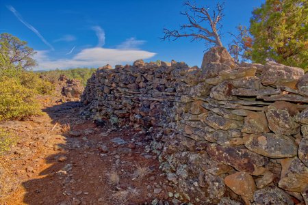 Photo for The crumbling walls of ancient Indian Ruins along the south rim of Rattlesnake Canyon near the historic Chavez Trail. Located in the Wet Beaver Creek Wilderness of Sedona Arizona. - Royalty Free Image