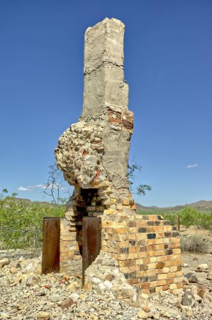 Photo for The ghostly remains of an old chimney from a home that burned down long ago in the ghost town of Freeman Arizona. - Royalty Free Image
