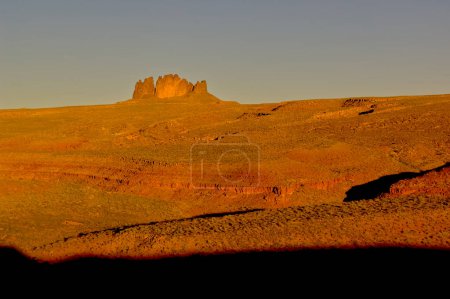 A view of Utah's Alhambra Rock from its northeast flank just after sunrise. It is located just southwest of the Valley of the Gods, which borders the San Juan River. From this perspective it resembles a lone fortress in the vast landscape. The name A