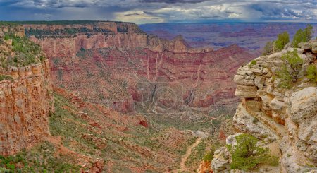 Sheer cliffs along the south rim of Grand Canyon Arizona east of Grandview Point with storm clouds in the sky during the 2022 Monsoon season.