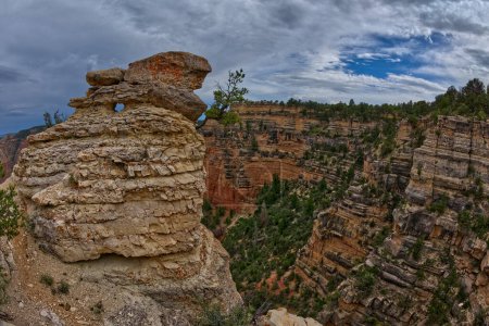Téléchargez les photos : Un pilier de roche sur les falaises de Grandview Point avec un trou en forme d'œil au Grand Canyon South Rim Arizona. - en image libre de droit