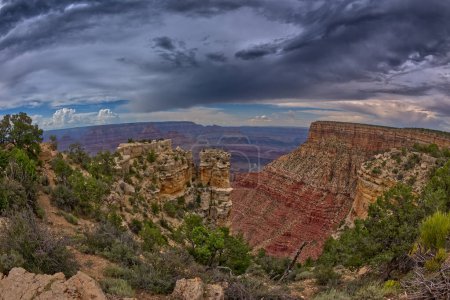 The rock island of Moran Point at Grand Canyon South Rim on a cloudy day. Zuni Point is just right of center in the distance.