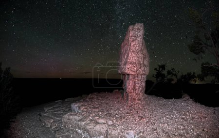An HDR composite photo of the Milky Way with the purplish glow of the Aurora Borealis viewed from Shoshone Point at Grand Canyon South Rim. The effect was created by stacking multiple photos together.