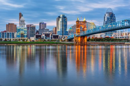 Photo for Cincinnati, Ohio, USA downtown skyline and bridge on the river at dusk. - Royalty Free Image