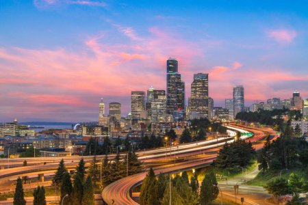 Seattle, Washington, USA downtown skyline and highways at dusk.