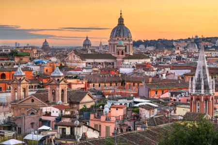 Italy, Rome cityscape with historic buildings and cathedrals at dusk.