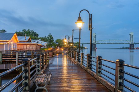 Wilmington, North Carolina, USA on the Riverwalk at twilight.