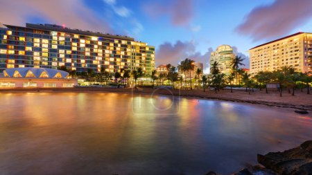 San Juan, Puerto Rico resort skyline on Condado Beach at twilight.