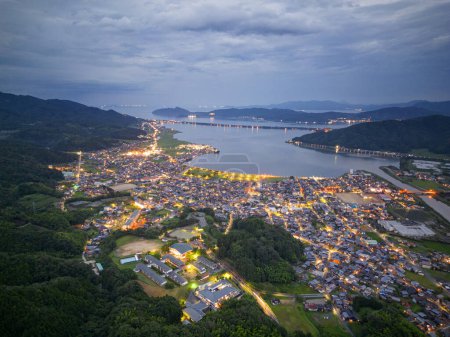 Photo for Amanohashidate, Kyoto, Japan over the bay with the sandbar in the distance at night. - Royalty Free Image