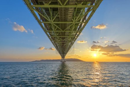 Photo for Akashi Kaikyo Bridge spanning the Seto Inland Sea from Awaji Island to Kobe, Japan at sunset. - Royalty Free Image