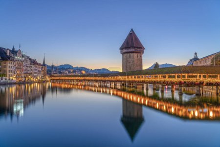 Photo for Lucerne, Switzerland with the Chapel Bridge and water tower over the River Reuss at dawn. - Royalty Free Image