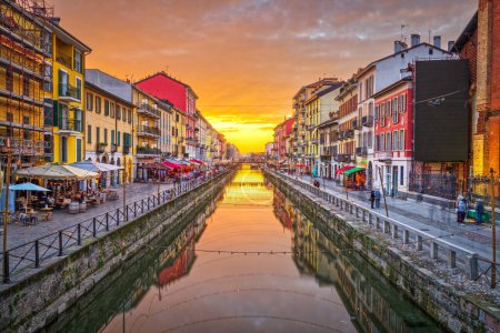 Photo for Naviglio Canal, Milan, Lombardy, Italy with a dramatic golden hour sky. - Royalty Free Image