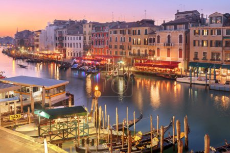 Photo for Venice, Italy overlooking boats and gondolas in the Grand Canal at dusk. - Royalty Free Image
