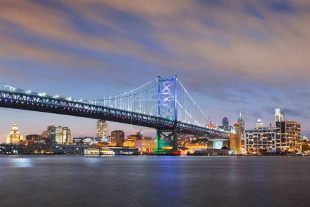 Photo for Philadelphia, Pennsylvania, USA skyline on the Delaware river with Ben Franklin Bridge at dusk. - Royalty Free Image