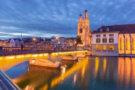 Famous Grossmunster churche and river Limmat at night in Old Town of Zurich, Switzerland