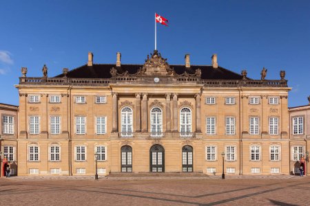 Amalienborg Royal Palace in Copenhagen, Denmark, featuring majestic banners fluttering in the breeze