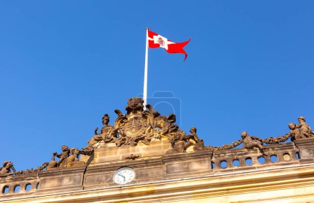 Amalienborg Royal Palace in Copenhagen, Denmark, featuring majestic banners fluttering in the breeze