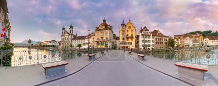 Panorama Reussbrucke bridge at sunrise with Jesuit Church in Old Town of Lucerne, Switzerland